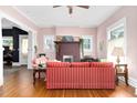 Comfortable living room featuring a brick fireplace, hardwood floors, and natural light at 302 Villa St, Rocky Mount, NC 27804