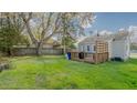 Spacious backyard with a wooden deck, ideal for outdoor entertaining and relaxation at 311 Oakley St, Graham, NC 27253