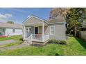 Cozy one-story home featuring a covered front porch with seating area at 311 Oakley St, Graham, NC 27253