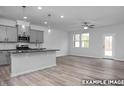 An open concept kitchen with island, granite countertops, stainless appliances and eat-in dining area at 3918 Well Fleet Dr, Fuquay Varina, NC 27526