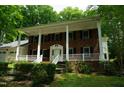 Beautiful brick home with a white-columned porch, shutters, and a well-manicured front yard at 4113 Oak Park Rd, Raleigh, NC 27612