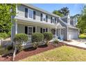 Charming two-story home featuring a well-manicured lawn, two-car garage, and welcoming front porch at 4309 Birmingham Way, Raleigh, NC 27604