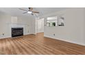 Spacious living room featuring a fireplace, ceiling fan, and open floor plan at 4309 Birmingham Way, Raleigh, NC 27604