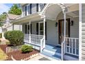 Close up on the porch, showing detail of the railing and front door at 4309 Birmingham Way, Raleigh, NC 27604