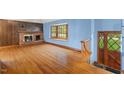 Spacious living room boasts hardwood floors, brick fireplace, and bright bay window at 502 Hiddenbrook Dr, Durham, NC 27703