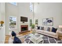 Spacious living room with fireplace, large windows, modern decor, and hardwood floors at 510 N Waters Edge Dr, Durham, NC 27703