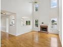 Bright living room with high ceilings, a fireplace, and large windows offering scenic views at 510 N Waters Edge Dr, Durham, NC 27703