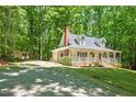 Side view of a home with a wraparound porch and a long gravel driveway at 524 Preston Andrews Rd, Bahama, NC 27503