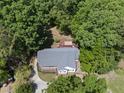Aerial view of a home surrounded by mature trees and a private backyard deck at 556 Margaret Pl, Garner, NC 27529