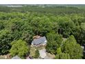 Aerial perspective of a secluded residence embraced by lush trees at 556 Margaret Pl, Garner, NC 27529