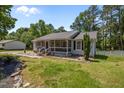 Delightful single-story home with a screened front porch and verdant landscaping, creating a welcoming curb appeal at 609 Chivalry Dr, Durham, NC 27703