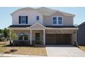 Charming two-story home with a covered entryway and spacious two-car garage at 701 Deschutes Dr, Garner, NC 27529