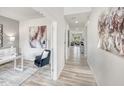 Inviting hallway features elegant decor, neutral colors and wood floors, creating a bright and airy feel at 701 Deschutes Dr, Garner, NC 27529