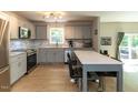 Bright, open kitchen with stainless steel appliances, gray cabinets, and a breakfast bar that seats two at 801 Madison Ave, Cary, NC 27513