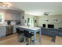 Modern kitchen with stainless steel appliances, gray cabinets, and a breakfast bar that seats two at 801 Madison Ave, Cary, NC 27513