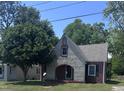 Charming stone and brick home with mature tree, arched entry, and well-maintained lawn at 808 Belvedere St, Rocky Mount, NC 27803