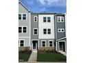 Charming new construction townhome showcases neutral colors and a well-manicured lawn at 808 Hillfarm Dr, Wake Forest, NC 27587