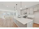 Bright, open kitchen featuring an island, stainless appliances, and hardwood floors at 808 Hillfarm Dr, Wake Forest, NC 27587