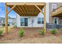 Exterior backyard with wood deck support, sliding glass doors, and green shrubbery at 860 Parc Townes Dr # 70, Wendell, NC 27591