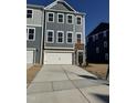 New construction townhome with gray siding, stone accents, and an attached garage at 860 Parc Townes Dr # 70, Wendell, NC 27591