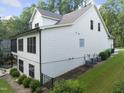 Back exterior view of a multi-story home with a mix of siding and brick finishes at 1005 Collins Dr, Raleigh, NC 27609
