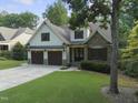 Charming two-story home with a manicured lawn, stone accents, and a two-car garage at 1005 Collins Dr, Raleigh, NC 27609