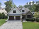 Beautiful two-story home with a stone facade and a spacious two-car garage at 1005 Collins Dr, Raleigh, NC 27609