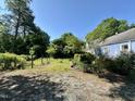 A lush backyard space with mature trees and greenery offers a serene outdoor environment at 1012 Virgie St, Durham, NC 27705