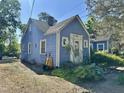 Blue single-Gathering home features a traditional design with a well-kept front yard and a welcoming front porch at 1012 Virgie St, Durham, NC 27705
