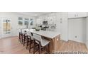 Open concept kitchen featuring a large island with seating, white cabinets, and stainless steel appliances at 106 Mable Ct # 15P, Lillington, NC 27546
