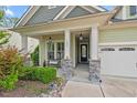 Inviting covered front porch with stone supports, a bench, and decorative hanging lanterns at 108 Boone St, Chapel Hill, NC 27516