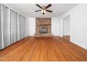 Bright living room featuring a stone fireplace and hardwood floors at 1103 Brucemont Dr, Garner, NC 27529