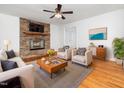 Inviting living room with a stone fireplace and hardwood floors at 1103 Brucemont Dr, Garner, NC 27529