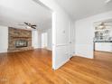 Open living room with fireplace, hardwood flooring, and natural light at 1103 Brucemont Dr, Garner, NC 27529