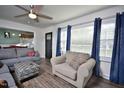 Comfortable living room with lots of natural light, neutral tones, modern ceiling fan, and view to dining room at 114 Short E St, Hillsborough, NC 27278