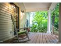 Inviting front porch with a rocking chair and view of the yard at 1149 Highway Nc 87, Pittsboro, NC 27312