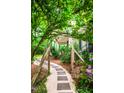Landscaped pathway leading to the house with greenery overhead at 1149 Highway Nc 87, Pittsboro, NC 27312