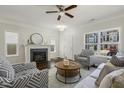 Cozy living room with a fireplace, comfortable seating, and natural light at 1211 Brown Velvet Ln, Apex, NC 27523