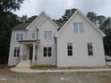 Beautiful two-story white brick house featuring a well-maintained lawn and classic architecture at 1444 Old Apex Rd, Cary, NC 27513