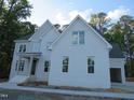 Charming two-story home with painted brick, side garage access, and mature trees at 1444 Old Apex Rd, Cary, NC 27513