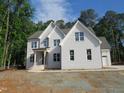 New construction home with painted brick, gable roof, and professionally landscaped yard at 1444 Old Apex Rd, Cary, NC 27513