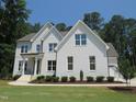 Beautiful two-story brick home with a landscaped front yard and charming architectural details at 1444 Old Apex Rd, Cary, NC 27513