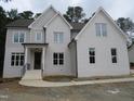 Charming two-story home boasts brick facade, elegant windows, and covered front porch at 1444 Old Apex Rd, Cary, NC 27513
