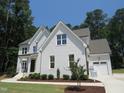 Attractive two-story home showcasing a brick facade, attached garage, and well-maintained landscaping at 1444 Old Apex Rd, Cary, NC 27513