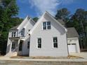 New construction home with painted brick, gable roof, and professionally landscaped yard at 1444 Old Apex Rd, Cary, NC 27513
