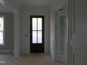 Foyer showcasing paneled wainscoting and a dark wood front door with glass panes at 1444 Old Apex Rd, Cary, NC 27513
