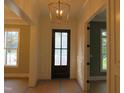 New construction foyer with designer lighting, paneled walls, and views to other rooms at 1444 Old Apex Rd, Cary, NC 27513