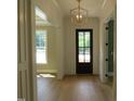 Elegant foyer with hardwood floors, decorative light fixture, and craftsman trim at 1444 Old Apex Rd, Cary, NC 27513