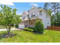Charming two-story home with a well-manicured lawn, a two-car garage, and attractive landscaping at 1613 Waddell Ct, Durham, NC 27703