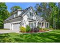 Side view of home showing attached garage and manicured landscaping at 165 Alpine Rd, Moncure, NC 27559